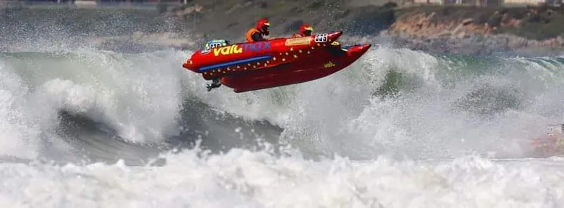 Racing boat launched off a wave in ocean conditions